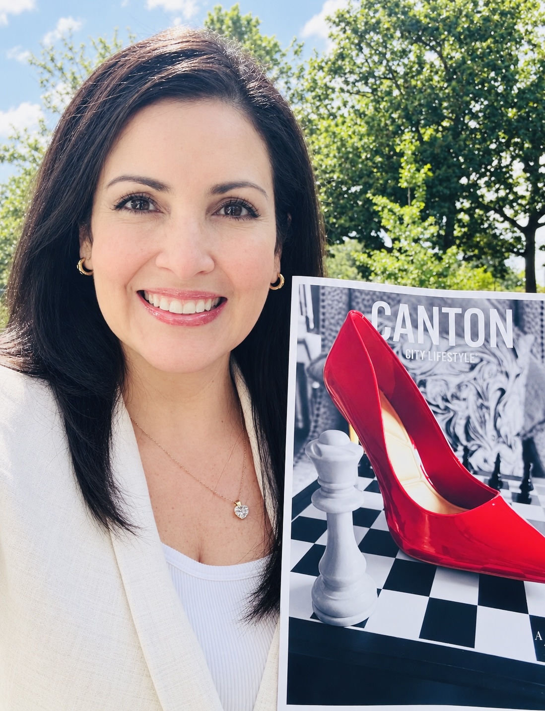 Dr. Carolina Blanco holding the Canton Lifestyle magazine